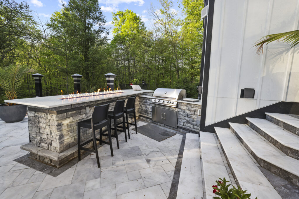 OutdoorBars02_floresLLC - Flores Landscapes Stone outdoor bar with fire table and grill in Columbus Ohio
