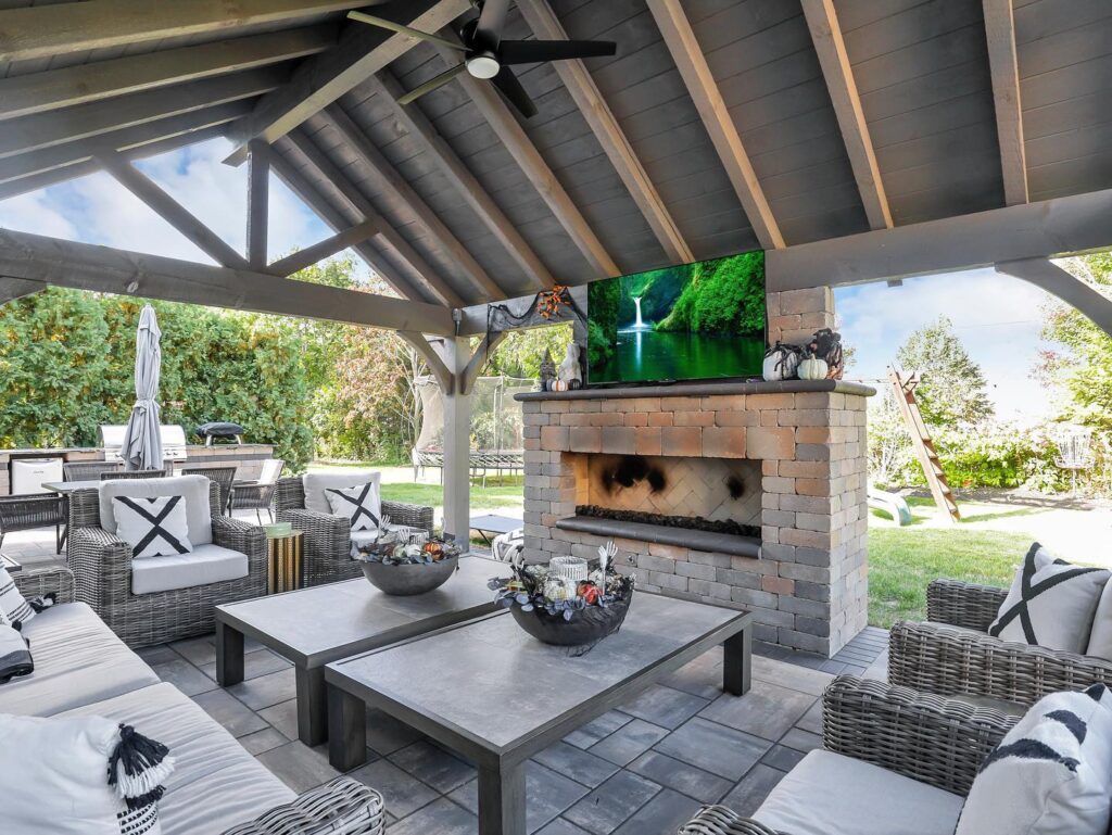Flores Outdoor Living Space #6 - Flores Landscapes Modern outdoor living space with brick fireplace and stone tables in Central Ohio