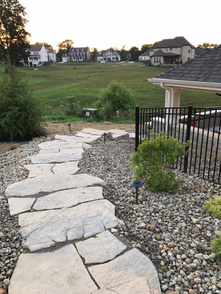 Flores Paver Pathway #3 - Flores Landscapes Natural stone paver path leading to a backyard patio with lush plantings – Central Ohio
