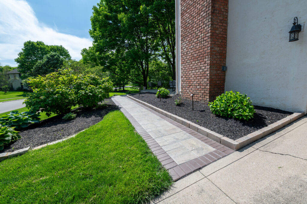 FloresLandscapingBlacklickHoaWall-1 1 - Flores Landscapes Custom paver pathway with brick edging and mulching in Central Ohio