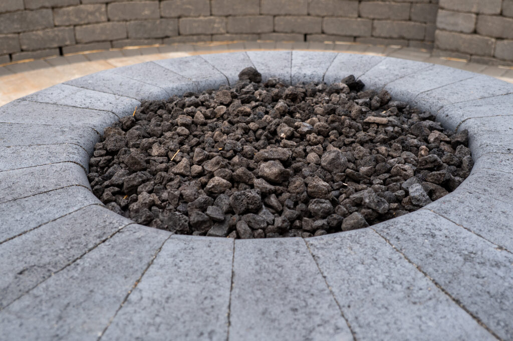 FloresLandscapingNealePatio-10 - Flores Landscapes Detailed close up of stone fire pit with custom stone in Central Ohio